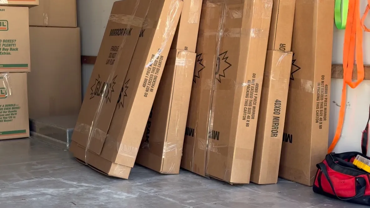 Specialty moving boxes stacked for packing mirrors and fragile items during a Florida move