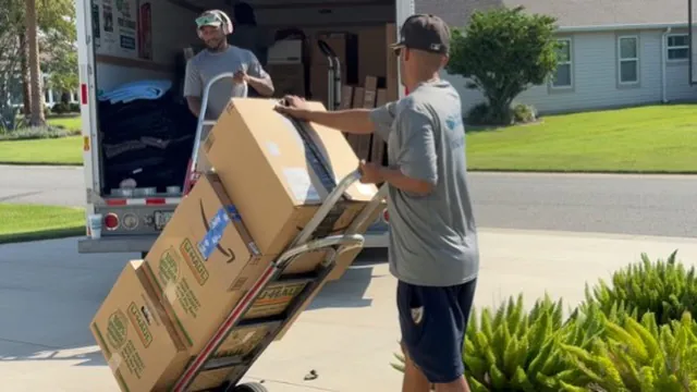 Mover using a dolly to transport a large box during a Florida move