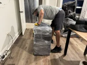 Mover shrink wrapping furniture for a residential move in Central Florida