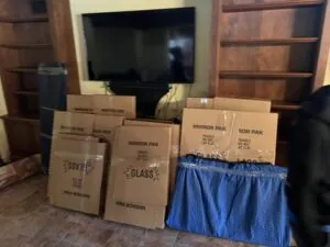 Packed moving boxes staged in living room for a Florida move with Village Movers and Storage